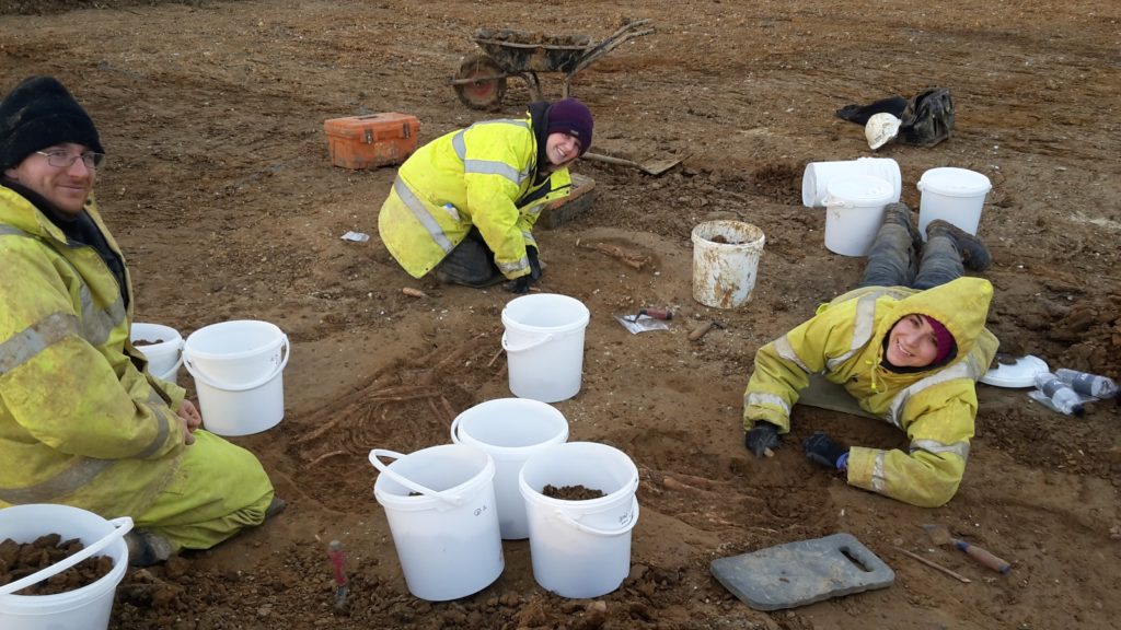 Archaeologists Joe Locke, Frances Bradbury and Diana De León Subias (L to R) excavate and record three Roman inhumation graves in Milton Keynes