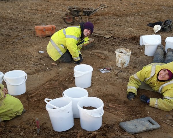 Archaeologists Joe Locke, Frances Bradbury and Diana De León Subias (L to R) excavate and record three Roman inhumation graves in Milton Keynes