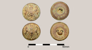Brass buttons depicting the King’s crown on the obverse and manufacturers stamp on the reverse