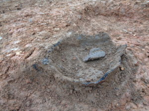 Photo 1: Bronze Age Vessel in-situ mid-excavation