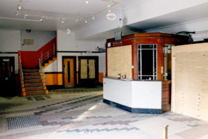 Photo 2: foyer with decorative tiled floor and kiosk
