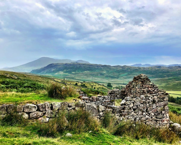 View across ruined huts towards Scafell Pike, Cumbria