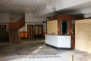 foyer with decorative tiled floor and kiosk